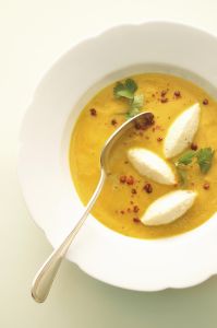 Coconut pumpkin soup with semolina dumplings, close-up