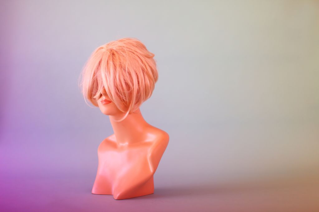 Mannequin Head Hiding Behind Blonde Wig