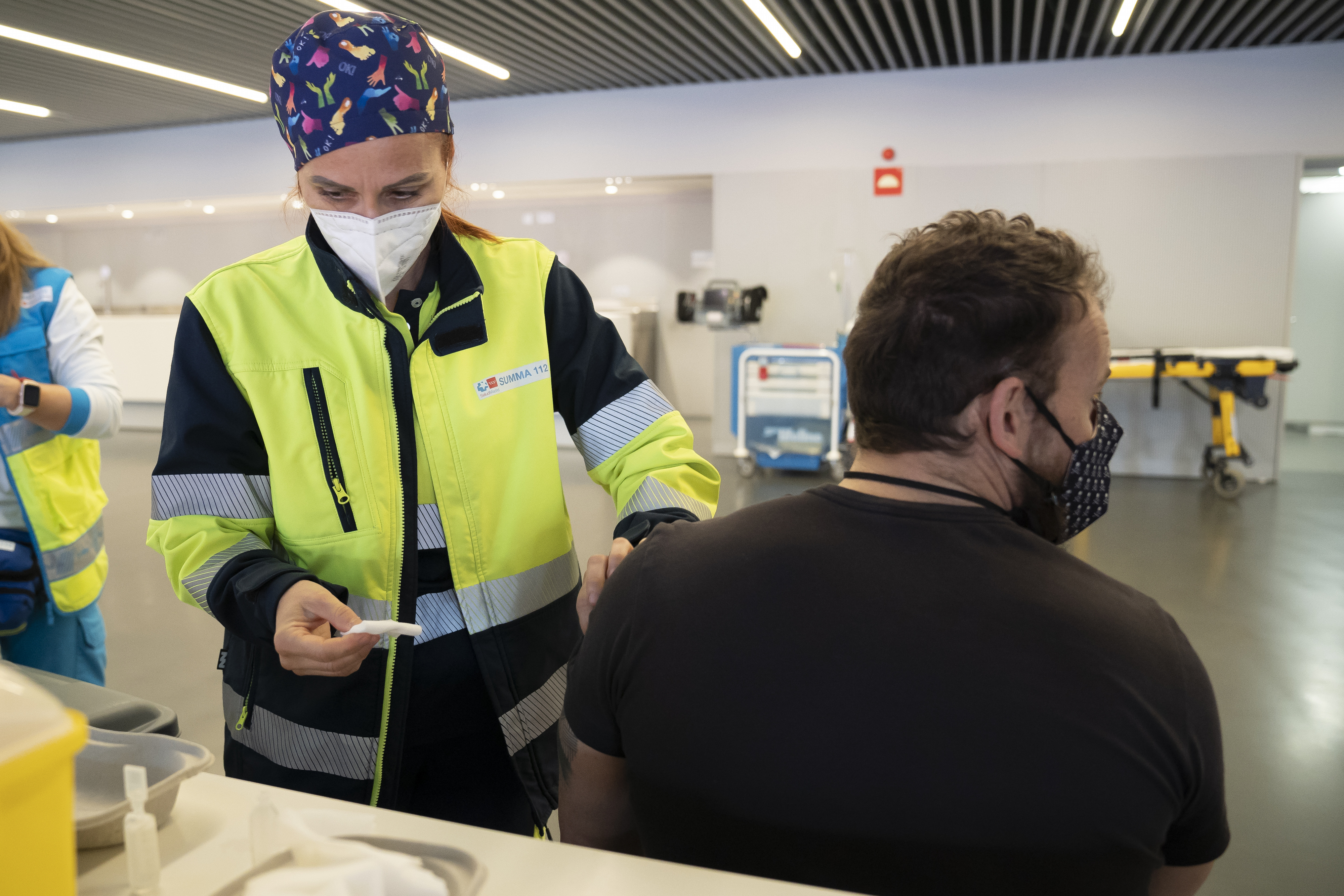 Wanda Stadium kicks-off Covid-19 vaccinations with police and fire forces receiving the first round in Madrid, Spain