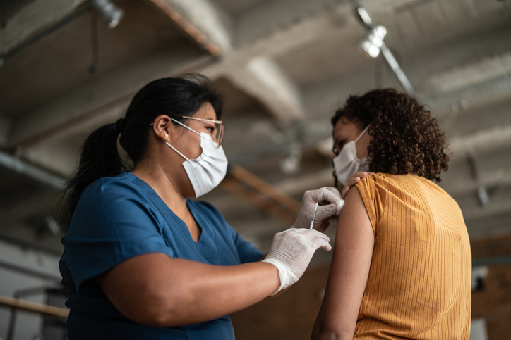 Teenage girl getting vaccinated in a medical clinic